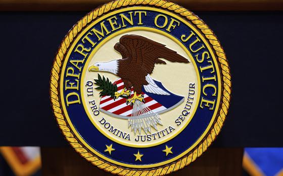FILE - The U.S. Department of Justice logo is seen on a podium before a press conference with Attorney General Pam Bondi, May 6, 2025, at the Justice Department in Washington. (AP Photo/Julia Demaree Nikhinson, File)