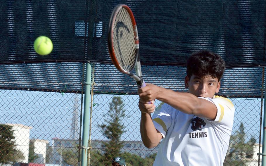 Kadena's Gabriel Fino strikes a backhand return during his boys singles semifinal loss to Kubasaki's Owen Ruksc.