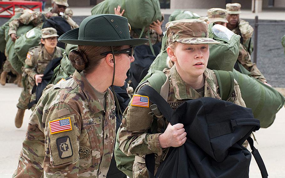 An Army drill sergeant corrects a recruit during her first day of training at Fort Leonard Wood, Mo., in 2017. A new study analyzed factors in the variability of injury rates for male and female service members.