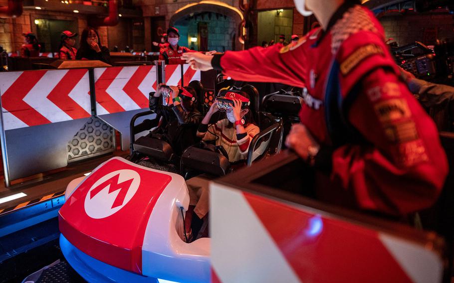 Guests on a Mario Kart-inspired ride at Universal Studios Japan, which utilizes augmented reality techniques, in Osaka on March 17, 2021. 