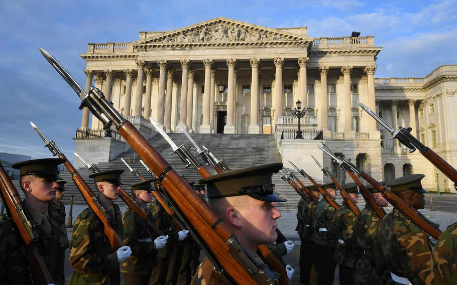 Military members in front of the Supreme Court building.