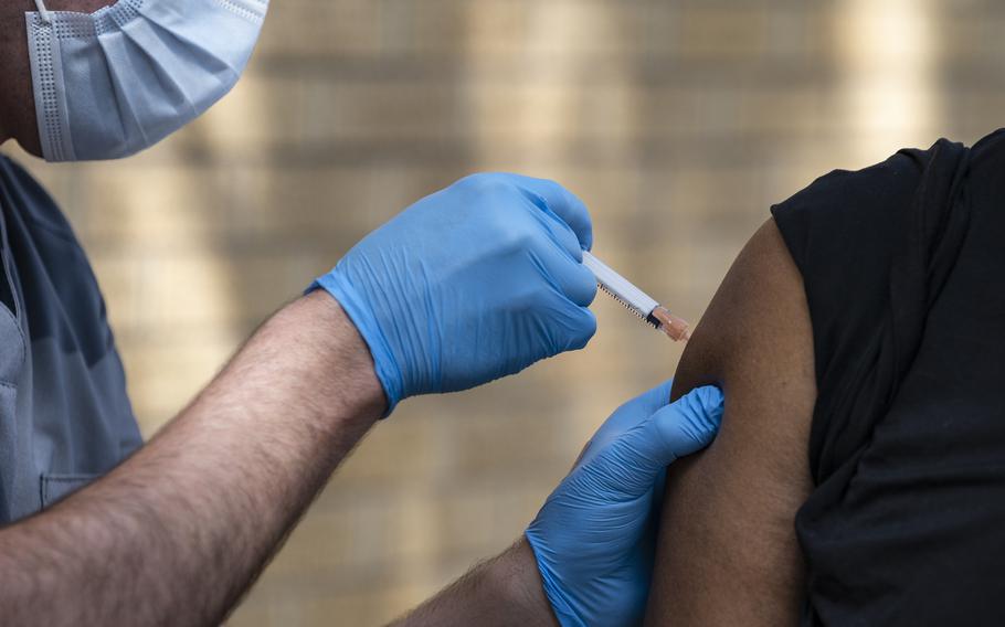 National Guard Spc. Noah Vulpi, left, administers the Johnson & Johnson COVID-19 vaccine to Ira Young Jr. during a vaccination clinic held by the National Guard in Odessa, Texas, on May 27, 2021.