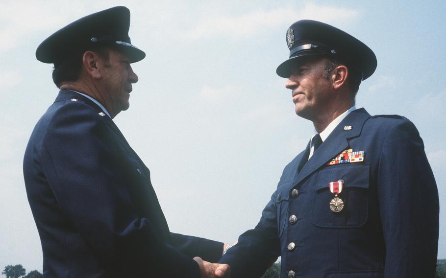 Decades after the last warrant officer retired from the U.S. Air Force, the service is considering reintroducing the rank. In this file photo, Gen. Robert E. Huyser, the head of Military Airlift Command, congratulates Chief Warrant Officer 4 James H. Long upon his retirement July 31, 1980. Long was the last to serve as a warrant officer on Air Force active duty.