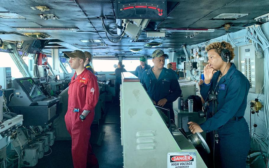 Sailors man the bridge on the aircraft carrier USS Dwight D. Eisenhower on March 20, 2024. Most of the ship's sailors are 18 to 24 years old and have jobs with significant responsibilities, such as driving the ship or maintaining its nuclear power system. 