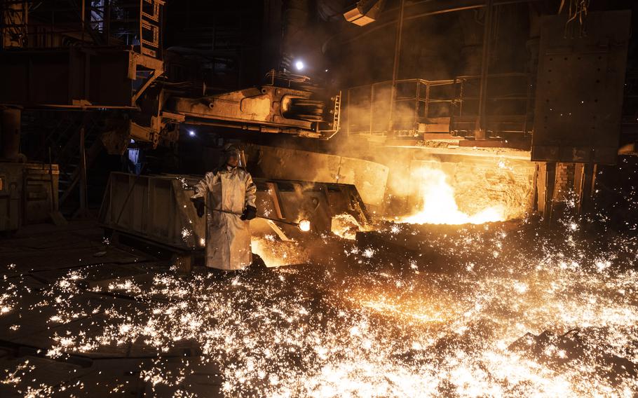 Oleksii Klashnik samples molten metal at the furnace of the Zaporizhstal steel plant.