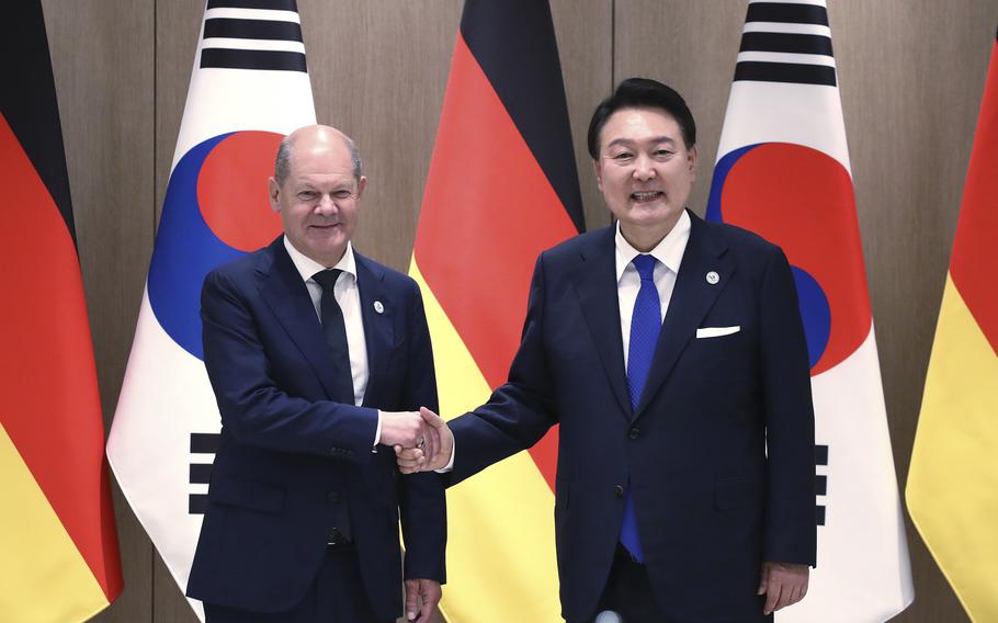 German Chancellor Olaf Scholz, left, and South Korea’s President Yoon Suk Yeol shake hands before their meeting at the Presidential Office in Seoul, South Korea, Sunday, May 21, 2023. Scholz arrived in Seoul on Sunday for the summit with Yoon after attending the G7 summit in Hiroshima, Japan.
