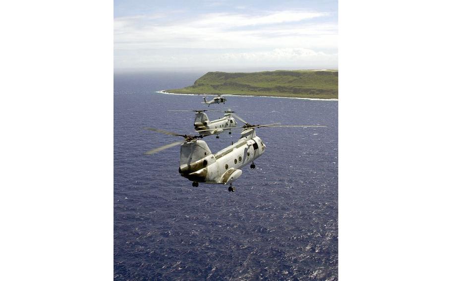 Two UH-46 Sea Knights and one MH-60 Knight Hawk fly toward Guam as a part of a six-helicopter formation during flight training in mid-January 2003. The helicopters were assigned to the Chargers of Helicopter Combat Support Squadron Five stationed at Andersen Air Force Base.