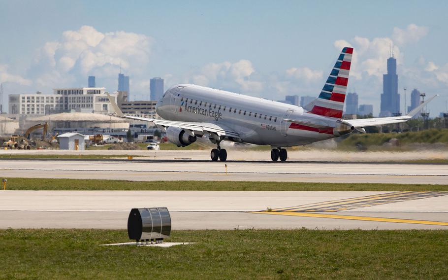 An American Eagle plane takes off in front of the Chicago skyline in September 2021 at O’Hare International Airport.