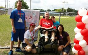 Darrell Lee, 72, center, was diagnosed with amyotrophic lateral sclerosis (ALS) in 2009. For the past several years, the Winter Garden resident has been cared for with the help of the James A. Haley Veterans’ Hospital in Tampa, his daughter Ashley Lee, right, and his granddaughter, Kaylei Lee, second from right. The Lees were at an ALS event several years ago. (Courtesy of Ashley Lee/TNS)
