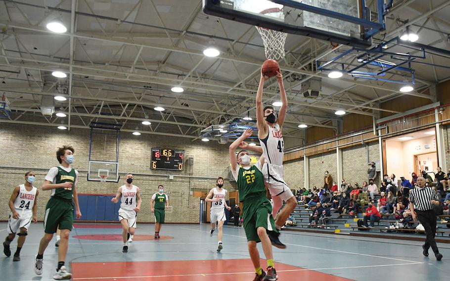 Lakenheath’s Gabriel Stephenson, the Lancers team captain, leaps high to try to score on a dunk against Alconbury in a game on Tuesday, Jan. 18, 2022.