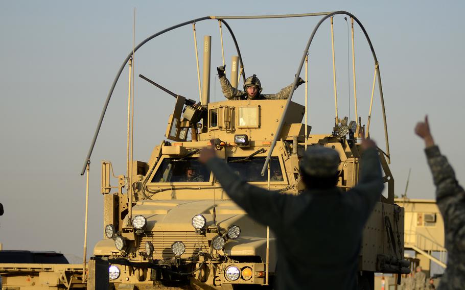 U.S. soldiers cheer for each other as the last U.S. military convoy to exit Iraq heads across the Kuwait border at the Khabari crossing, Dec. 18, 2011. About 2,500 U.S. troops are in Iraq as of 2023 to help prevent a resurgence of the Islamic State group.