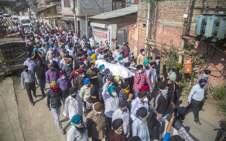 In this Oct. 8, 2021 file photo, Sikh community members carry the body of slain Satinder Kaur, a government school teacher during her funeral procession in Srinagar, India.