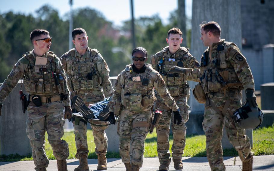 Air National Guard Security Forces airmen transport a role-play injured victim during a PATRIOT 24 search and rescue exercise, Camp Shelby, Miss., Monday, Feb. 19, 2024.