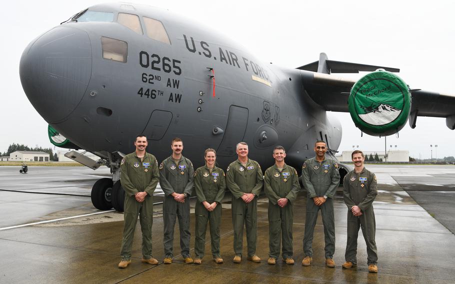 Air Force Brig. Gen. Derin Durham, commander of the 4th Air Force, center, is flanked by six reservists from the 446th Airlift Wing at Joint Base Lewis-McChord, Wash. The crew received the Distinguished Flying Cross for their efforts in the U.S. withdrawal from Afghanistan in 2021.
