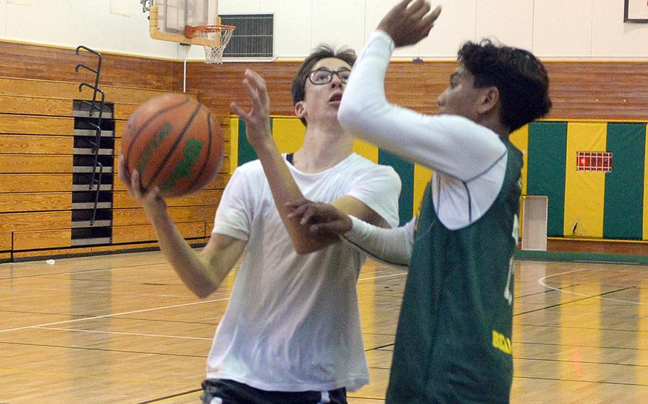 Robert D. Edgren senior Gabe Simmons drives to the basket against sophomore Micah Magat.