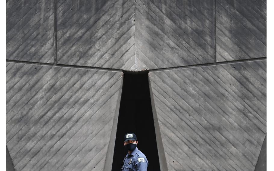 A security member walks outside the Department of Housing and Urban Development on May 17, 2021, in Washington, D.C. Two months after the Biden administration’s deadline for federal workers to be vaccinated against coronavirus so they could begin returning to the office, the government’s plan to resume normal operations remains muddled.