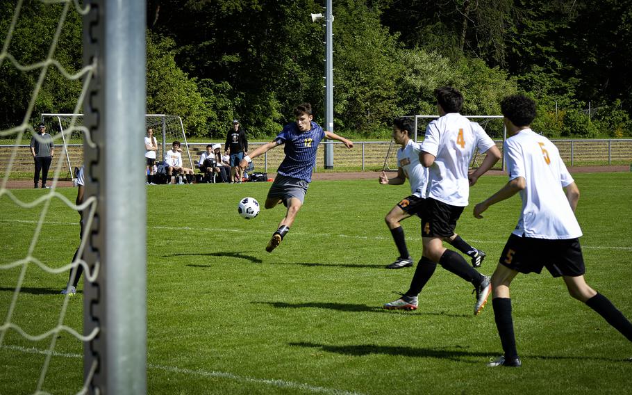 Lucas Rudy of Ansbach takes a shot on goal against Spangdahlem’s three-man defense during the 2024 DODEA European Soccer Division III Championships in Landstuhl, Germany, on May 20, 2024. Defending are, from left, Troy Truscott, Logan Simmers, and Mason Tieyah.