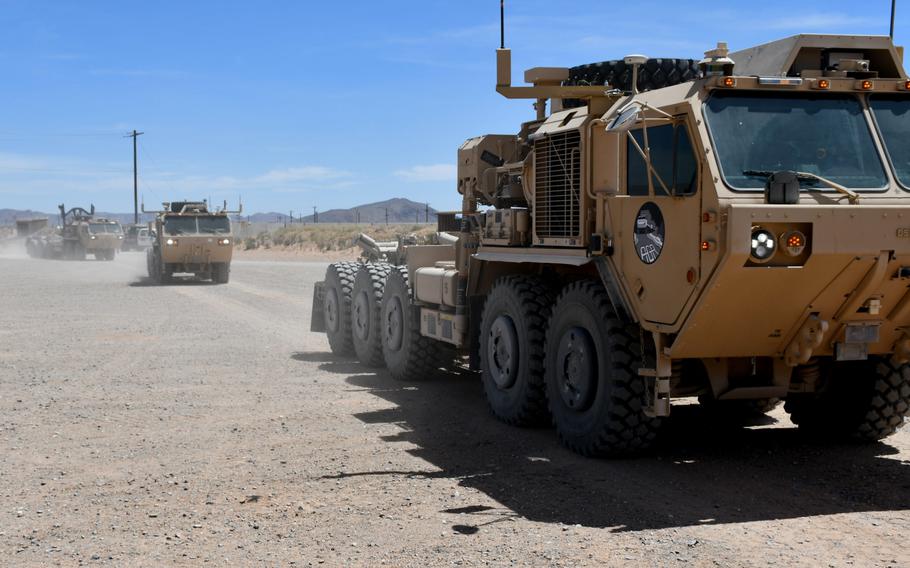 A convoy of semi-autonomous trucks rolls past during a dedication ceremony at Fort Bliss, Texas, in 2019.