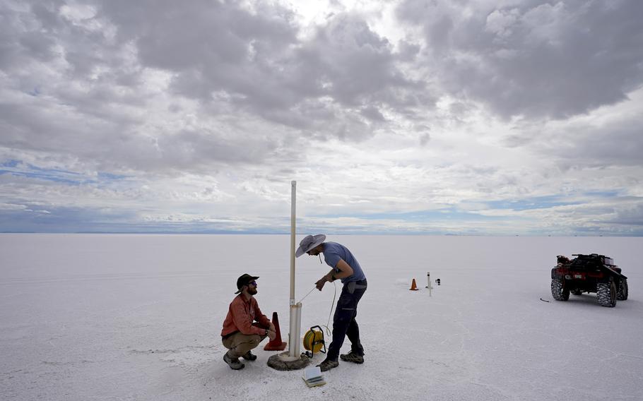 State biologists collects water samples in the Bonneville Salt Flats Tuesday, Sept. 13, 2022, near Wendover, Utah.  The glistening white salt of the world famous area is shrinking near the Utah-Nevada line. 