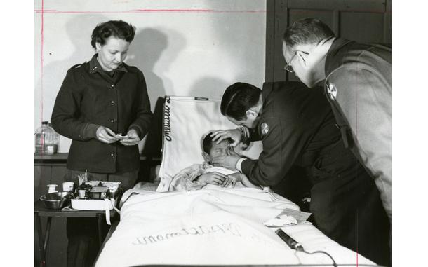 Hed: First light, first sight, 1954

After groping through 12 years of darkness, a little Korean boy, Lee Toi Byun, was given his sight recently after an operation performed by Maj. G. Peter Halberg a New York eye specialist at the 121st Evac. Hosp. near Seoul. Shown examining the boy after one cataract was successfully removed are (left to right) 1st Lt. Phyllis Duke, Lee, Col. William L. Spaulding, hospital commander, and Halberg.

 Col. William L. Spaulding, commanding officer of the 121st Evacuation Hospital and Eight Army consulting ophthalmologist, examines the eye of 12-year-old Lee Toi Byun. Lee just had cataract removed from his right eye by Maj. G. Peter Halberg (right), an eye specialist at the 121st. Halberg found Lee in a Korean clinic and brought him to the evacuation hospital where adequate facilities for the cataract surgery are available. Surgery on the left eye will follow soon. 

Looking for Stars and Stripes’ historic coverage? Subscribe to Stars and Stripes’ historic newspaper archive! We have digitized our 1948-1999 European and Pacific editions, as well as several of our WWII editions and made them available online through https://starsandstripes.newspaperarchive.com/

META TAGS: Pacific; South Korea; military medical; Korean; child; boy; hospital; bed; Evacuation Hospital; nurse; doctor; medical examination; sight; blind; blindness