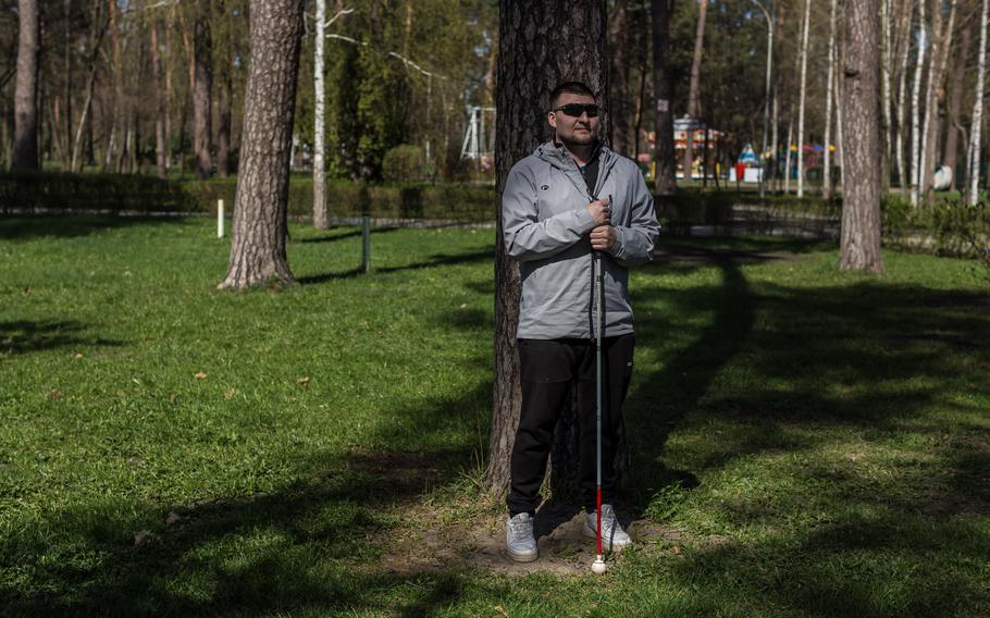 Ukrainian veteran Denys Abdulin, 35, at a park in Kyiv on April 5, 2024. Abdulin lost the use of both eyes two years ago after shrapnel from a mortar pierced his skull through his left ear and exited his right eye.