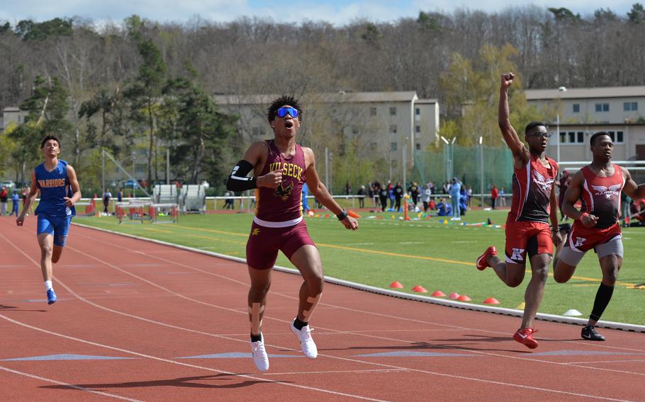 Vilseck’s Trevon Vargas cheers over his victory during his 200-meter dash heat while  Kaiserslautern Raider Kemka Okoroafor celebrates a second-place finish at the Kaiserslautern Track and Field Invitational on Saturday, April 16, 2022, in Kaiserslautern, Germany. 