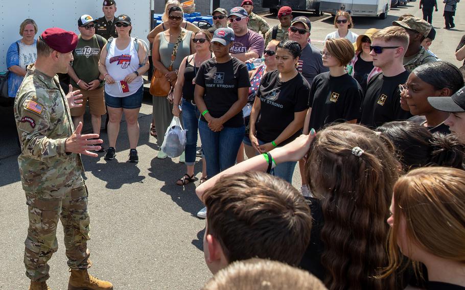 Brig. Gen. Brandon Tegtmeier speaks with new U.S. Army recruits during a NASCAR race May 29, 2022, at Charlotte Motor Speedway, N.C. The U.S. Army is doing away with its requirement that enlistees have a GED or high school diploma, a move designed to help meet recruiting goals.