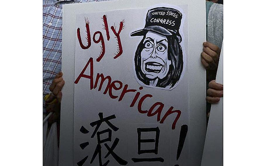 A video screen grab shows a demonstrator holding poster depicting U.S. House Speaker Nancy Pelosi as she planned to visit Taiwan, a trip that threatened to disrupt the careful relationship between China, Taiwan and the United States.