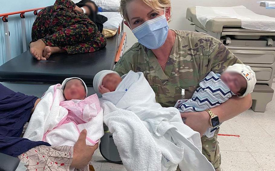 Dr. (Maj.) Elaina Wild, 379th Expeditionary Medical Group chief medical officer, with mothers and their newborn babies at Al Udeid Air Base, Qatar, Aug. 28, 2021. Since the base became the main stopover location for evacuees from Afghanistan on Aug. 14, 2021, members assigned to the unit helped deliver nine babies.