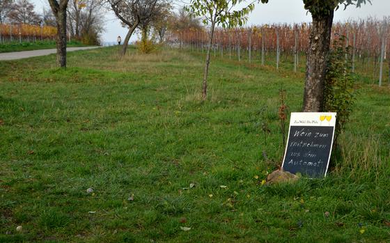 A sign near the ''wine education trail'' in Maikammer, Germany, informs passersby that there is a wine vending machine just steps away at Winzerhof Ernst winery. The machine sells reds, whites and roses, grape juice, water and glasses to drink purchases from.

Karin Zeitvogel/Stars and Stripes