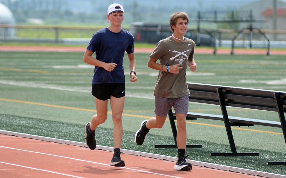 Joey Brown and Ammon Allen run in practice.