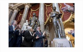 From left, North Carolina Gov. Roy Cooper, Sen. Ted Budd, R-N.C., Rep. Virginia Foxx, R-N.C., and Speaker of the House Mike Johnson, R-La., applaud as they unveil a bronzed sculpture of the late Rev. Billy Graham is unveiled at the U.S. Capitol in Washington, where it will stand on behalf of his native North Carolina, Thursday, May 16, 2024. Known as America's pastor, Graham died in 2018 at age 99. (AP Photo/J. Scott Applewhite)