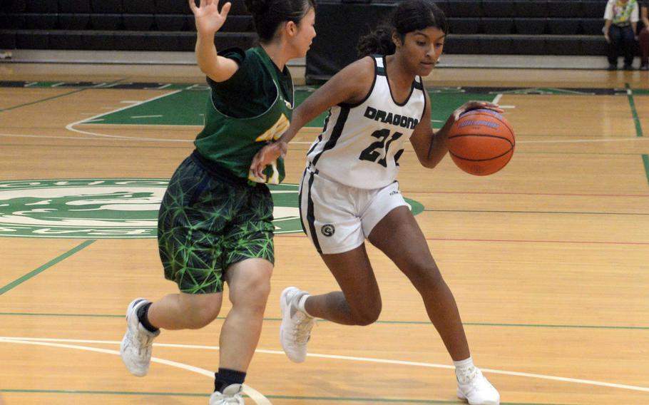 Kubasaki's Solares Solano drives against a Koza defender during Tuesday's Okinawa girls basketball game. Koza won 57-37.