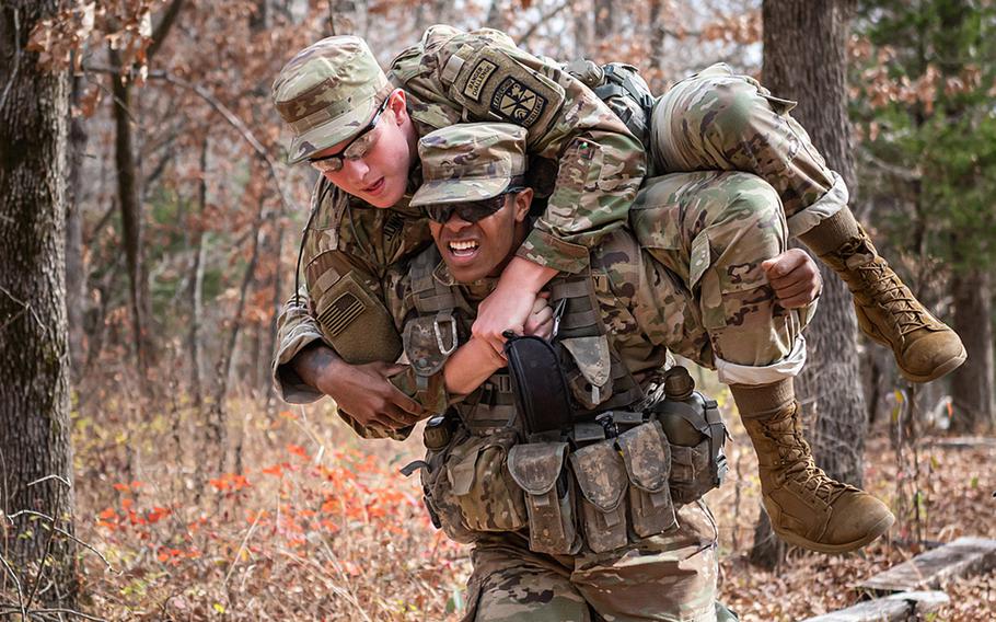 University of Iowa cadet Trejahn Manning carries teammate Joseph Junker to the finish line in November 2022 during the 3rd Brigade ROTC Ranger Challenge competition at Fort Leonard Wood, Mo. The pool of military officers participating in ROTC programs has become more diverse, according to a recently released Government Accountability Office report.