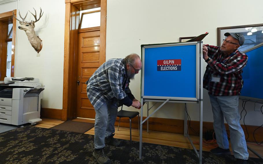 Election workers Greg Petty, left, and Richard Conklin close down a voting station for the day on Friday at Gilpin County Courthouse in Central City, Colo. 