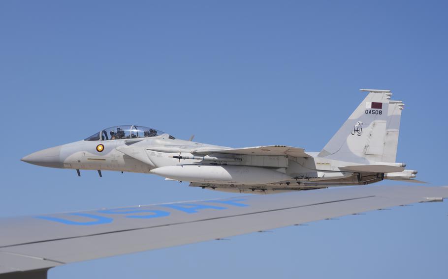 An F-15 fighter jet escorts Air Force One.