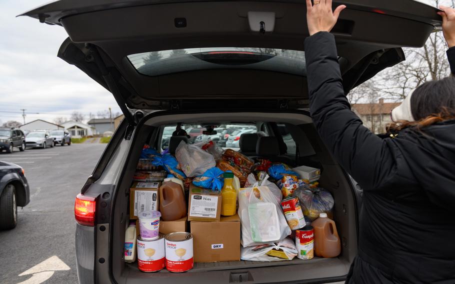 A volunteer loads a vehicle at the Beaver County Food Bank in Monaca, Pa., on Dec. 7, 2021. U.S. poverty fell overall in 2020, a surprising decline that is largely a result of the swift and large federal aid that Congress enacted at the start of the pandemic to try to prevent widespread financial hardship as the nation experienced the worst economic crisis since the Great Depression.