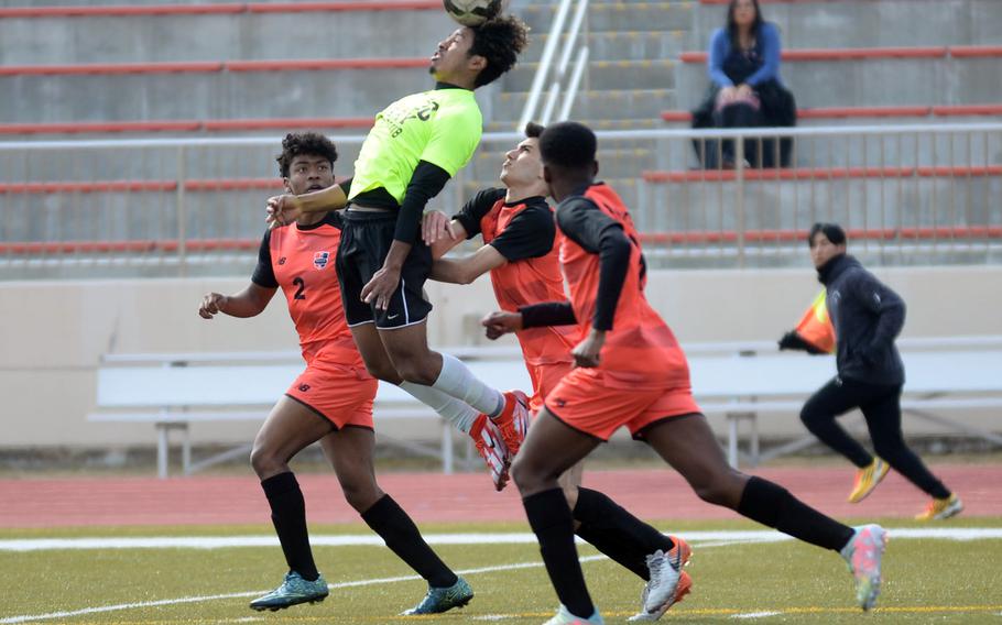 Matthew C. Perry's Denzel Gray leaps to head the ball over the Nile C. Kinnick defense during Friday's Perry Cup soccer matches. The Red Devils won 8-0.