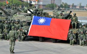 Members of Taiwan’s 564th Armored Brigade present their flag after demonstrating their ability to repel an airborne attack near Kaohsiung, Taiwan, Jan. 11, 2023. 