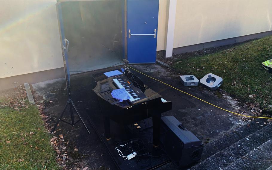 A piano and audio equipment dries outside KMC Onstage, after an equipment malfunction activated fire sprinklers and flooded the stage at Kleber Kaserne, Kaiserslautern, Germany, Feb. 13, 2022.