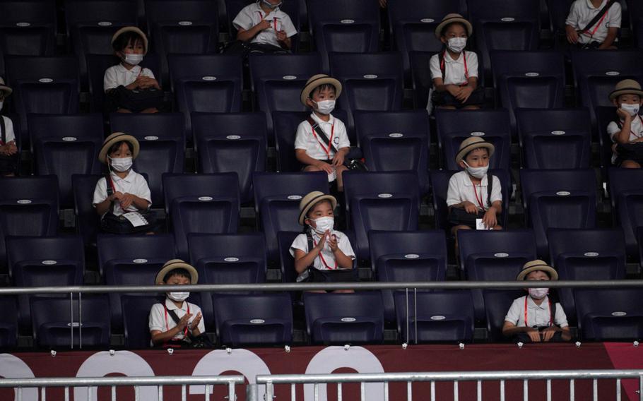 Japanese schoolchildren watch a Paralympics wheelchair rugby match between the United States and New Zealand at Yoyogi National Stadium in Tokyo, Wednesday, Aug. 25, 2021. 