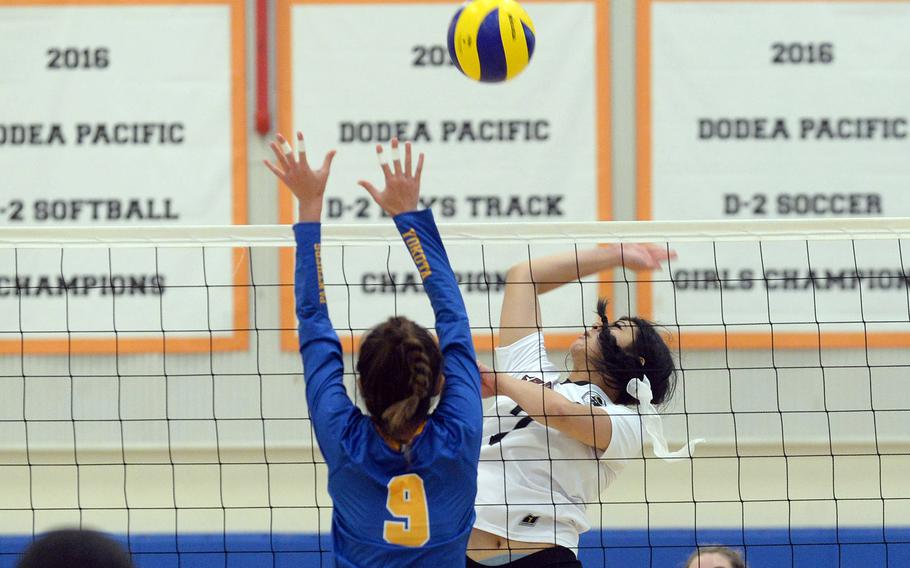 Matthew C. Perry's Raelin Reyes hits against Yokota's Erica Haas during Saturday's DODEA-Japan girls volleyball match. The Panthers won in four sets.