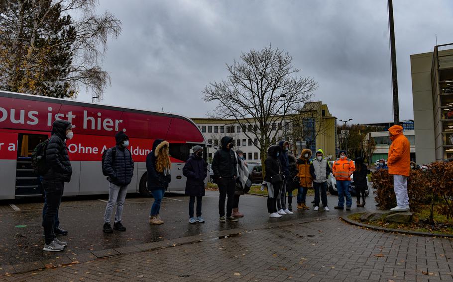 A volunteer with the Red Cross briefs volunteer recipients on the possible side effects for the available COVID-19 vaccines in Kaiserslautern, Germany, Nov. 30, 2021. Vaccine buses supplement vaccination centers as a major outlet for the vaccination effort in Germany.