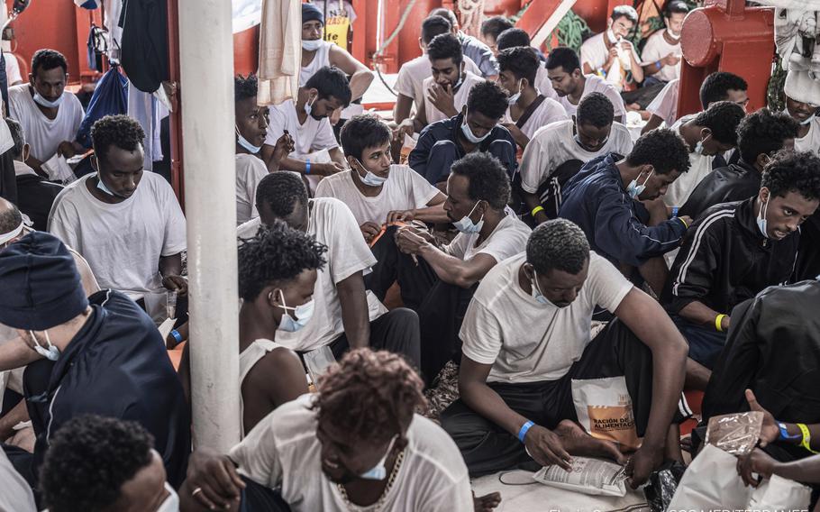 Migrants receive food while aboard the Ocean Viking rescue, in the Mediterranean Sea on Thursday, July 8, 2021. 