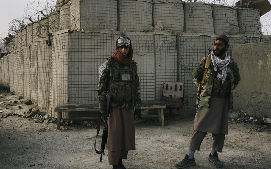 Esmatullah Omari, left, at a checkpoint near Bagram air base. 