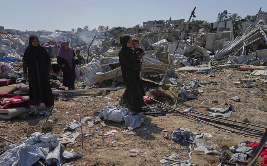 Palestinian women check destruction.