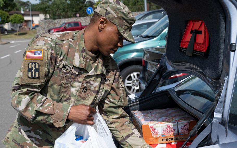 Army Sgt. 1st Class Joshua Mero loads groceries into his car at Ramstein Air Base on Monday, May 25, 2022.