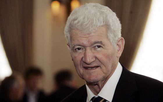 Mathematician Peter Lax wearing a black suit.