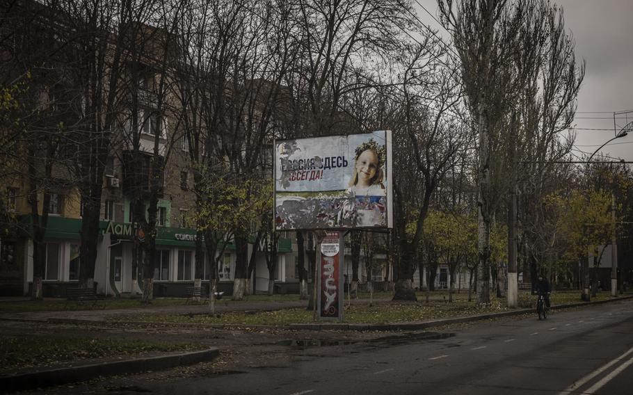 A damaged billboard proclaiming “Russia is here forever” seen from a car in central Kherson city on Nov. 18, 2022. Ukrainian troops pushed Russian forces to flee city after more than eight months of occupation but there is no sign the war in Ukraine will end anytime soon.