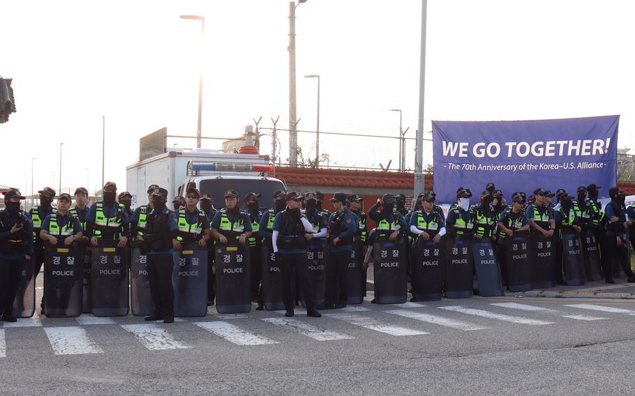 South Korean police form a line to keep protesters from entering the main gate at Camp Humphreys, South Korea, Thursday, July 27, 2023. 
